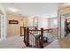 Upstairs hallway with natural lighting and hardwood railing at 6502 Shea Pl, Highlands Ranch, CO 80130