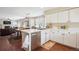 Bright kitchen boasts white cabinetry, stainless steel appliances, and a charming breakfast nook at 6502 Shea Pl, Highlands Ranch, CO 80130
