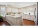 Bright kitchen with white cabinets, tiled countertops, and modern appliances at 6502 Shea Pl, Highlands Ranch, CO 80130