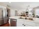 Modern kitchen with stainless steel appliances and an island that overlooks the living area at 6502 Shea Pl, Highlands Ranch, CO 80130