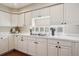 Well-lit kitchen featuring white cabinets and tiled countertops at 6502 Shea Pl, Highlands Ranch, CO 80130