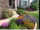 Beautifully landscaped front yard with vibrant flowers and a well-maintained walkway at 6502 Shea Pl, Highlands Ranch, CO 80130