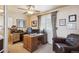 Bright office with an executive desk, ample shelving, and comfortable seating area at 6502 Shea Pl, Highlands Ranch, CO 80130