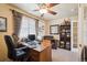 Well-lit office featuring a wooden desk, a ceiling fan, and built in shelving at 6502 Shea Pl, Highlands Ranch, CO 80130