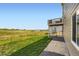 Spacious backyard featuring lush grass, fencing, and a view of the home's elevated wooden deck at 42830 Ivydel St, Elizabeth, CO 80107