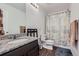 Bright bathroom with granite countertop on vanity and a view of the toilet and shower at 42830 Ivydel St, Elizabeth, CO 80107