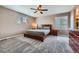 Cozy bedroom with a king bed, soft carpet, natural light, and wood furniture at 42830 Ivydel St, Elizabeth, CO 80107