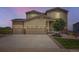 Charming home featuring a three-car garage, well-maintained landscaping, and a welcoming front facade at 42830 Ivydel St, Elizabeth, CO 80107
