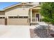 Charming tan two story home with a 3-car garage, well maintained lawn, and stone accents at 42830 Ivydel St, Elizabeth, CO 80107