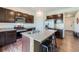 Kitchen features granite counters, dark wood cabinets, stainless steel appliances and a center island at 42830 Ivydel St, Elizabeth, CO 80107