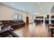 Expansive living room with wood floors opens to dining and kitchen areas, bathed in natural light at 42830 Ivydel St, Elizabeth, CO 80107
