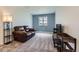 Cozy living room features a comfortable leather couch and a large window offering scenic views at 42830 Ivydel St, Elizabeth, CO 80107