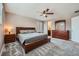 Comfortable main bedroom with wood furniture, soft carpet, and ensuite bathroom at 42830 Ivydel St, Elizabeth, CO 80107
