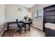 Comfortable office with sleek black desk, shelving, plush chair, and bright natural light at 42830 Ivydel St, Elizabeth, CO 80107
