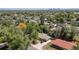 This aerial view showcases the property within a lush, green neighborhood with mature trees at 140 S Kendall St, Lakewood, CO 80226