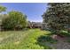 Large grassy backyard featuring play set and shed at 140 S Kendall St, Lakewood, CO 80226