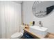 A modern bathroom is finished with a sleek vessel sink and chic design at 140 S Kendall St, Lakewood, CO 80226