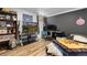 Bedroom with dark accent wall, wood flooring and large TV at 140 S Kendall St, Lakewood, CO 80226