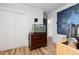 This bedroom contains a dresser with an aquarium, and access to the hallway at 140 S Kendall St, Lakewood, CO 80226