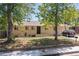 Charming single-story home with brick facade, complemented by mature trees and a well-maintained front yard at 140 S Kendall St, Lakewood, CO 80226