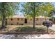 Charming single-story home with brick facade, complemented by mature trees and a well-maintained front yard at 140 S Kendall St, Lakewood, CO 80226