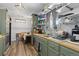The well-lit kitchen features stainless steel appliances, wooden countertops, and an open layout at 140 S Kendall St, Lakewood, CO 80226