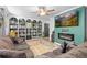 Comfortable living room featuring a built-in bookcase, a cozy couch, and a modern fireplace at 140 S Kendall St, Lakewood, CO 80226