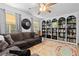 Bright living room with built-in bookcase and comfortable couch near a window offering natural light at 140 S Kendall St, Lakewood, CO 80226