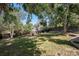 Lush backyard with green grass, mature trees, and garden beds provides a serene outdoor space at 6532 S Field Way, Littleton, CO 80123