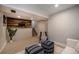 Finished basement space with a wood accent wall, stairs, and comfortable seating for Gathering entertainment at 6532 S Field Way, Littleton, CO 80123