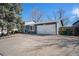 Lovely home featuring a two-car garage, blue exterior paint, and well-manicured landscaping at 6532 S Field Way, Littleton, CO 80123