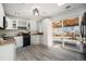 Stylish kitchen with modern appliances, white cabinets, and an opening that looks to the backyard at 6532 S Field Way, Littleton, CO 80123