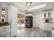 Modern kitchen featuring stainless steel appliances, white cabinetry, and sliding glass doors to the backyard at 6532 S Field Way, Littleton, CO 80123