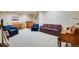 Wide angle of a finished basement featuring a piano, seating, and a kitchenette area at 15501 E 112Th Ave # 33D, Commerce City, CO 80022