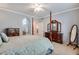 Bedroom featuring four-poster bed, neutral carpeting, and ensuite bath at 15501 E 112Th Ave # 33D, Commerce City, CO 80022