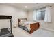 Bright bedroom equipped with a treadmill, window, and neutral carpeting at 15501 E 112Th Ave # 33D, Commerce City, CO 80022