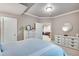 Bedroom with white dressers and view into living room at 15501 E 112Th Ave # 33D, Commerce City, CO 80022