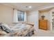 Well-lit bedroom features a comfortable bed, window, closet, and dresser for ample storage at 15501 E 112Th Ave # 33D, Commerce City, CO 80022