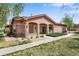 Charming single-story home featuring a covered porch and well-maintained front yard at 15501 E 112Th Ave # 33D, Commerce City, CO 80022