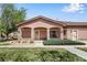 Charming home exterior with manicured lawn, stone pillars and covered front porch at 15501 E 112Th Ave # 33D, Commerce City, CO 80022