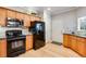 Stylish kitchen with wood cabinets, granite countertops and black appliances at 15501 E 112Th Ave # 33D, Commerce City, CO 80022
