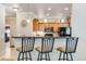 Open kitchen view with breakfast bar, pendant lighting, and stainless steel appliances at 15501 E 112Th Ave # 33D, Commerce City, CO 80022