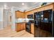 Kitchen featuring wood cabinets, granite countertops, and stainless steel appliances at 15501 E 112Th Ave # 33D, Commerce City, CO 80022