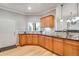 Kitchen featuring wood cabinets, granite countertops, backsplash, double sink, and exterior door at 15501 E 112Th Ave # 33D, Commerce City, CO 80022