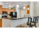 Updated kitchen featuring breakfast bar with barstool seating and modern appliances at 15501 E 112Th Ave # 33D, Commerce City, CO 80022