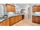 Inviting kitchen with wood cabinets, granite countertops, backsplash, and a double sink at 15501 E 112Th Ave # 33D, Commerce City, CO 80022