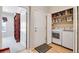 Laundry room with washer, dryer, utility sink and shelving at 15501 E 112Th Ave # 33D, Commerce City, CO 80022