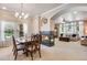 Open concept living room and dining area with fireplace and ample natural light at 15501 E 112Th Ave # 33D, Commerce City, CO 80022