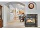 Open-concept living room with fireplace, archway, and view of the eat in kitchen at 15501 E 112Th Ave # 33D, Commerce City, CO 80022