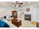 Spacious living room featuring a fireplace, wooden furniture, and modern lighting at 15501 E 112Th Ave # 33D, Commerce City, CO 80022